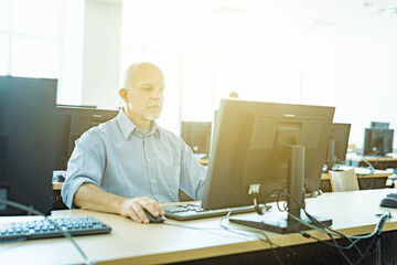 High key image of a businessman at work with sun flare