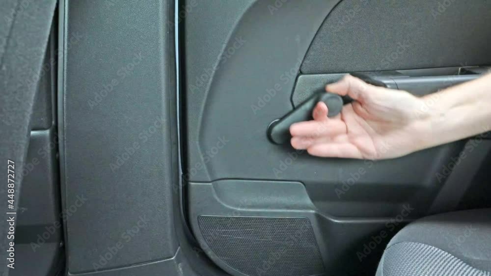 Canvas Prints a closeup shot of a male hand opening an old car window, spinning the roller handle in 4k