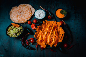 nachos with cheese and guacamole mexican food in bowl darkfood style