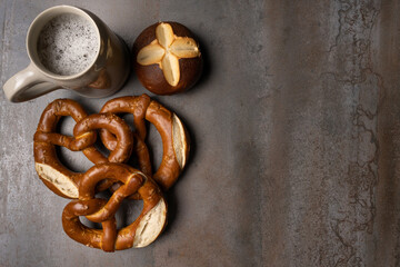 oktoberfest food with pretzels and beer background