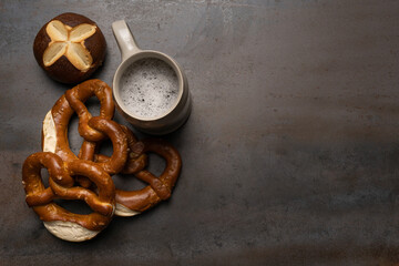 oktoberfest food with pretzels and beer background