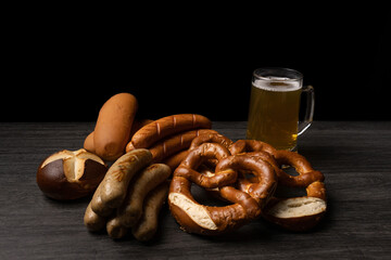 oktoberfest food and drinks beer pretzels and sausages on table 