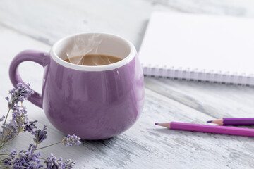 Hot coffee cup, coffee with milk and notepad on wooden table 