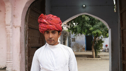 Young Indian man in traditional clothes and turban walking outdoor