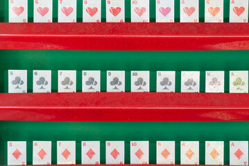 Playing cards are displayed in a row in a dash.