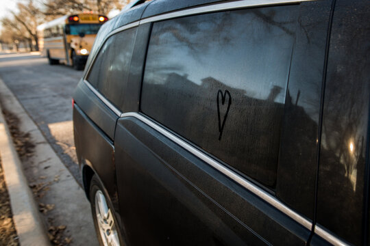 Heart Drawn On Van Window With School Bus Approaching