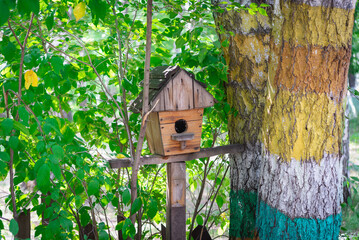 Birdhouse near a tree in the park.