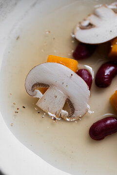 Food: Consome of Ceps, pumpkin gnochi and black beans