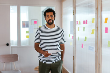Positive man with paper in office