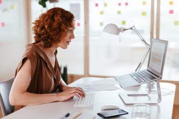 Businesswoman working on laptop in office