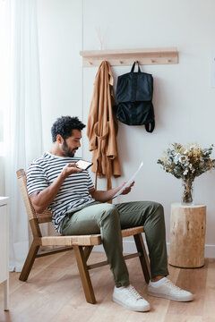 Man with smartphone reading document