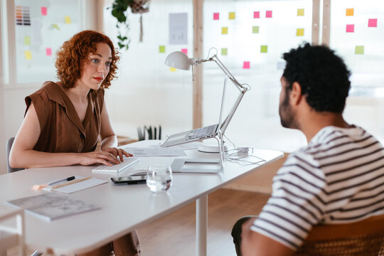 Colleague discussing business results in office