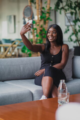 smiling black girl taking a selfie herself