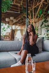 Obraz premium smiling black girl sitting on her armchair