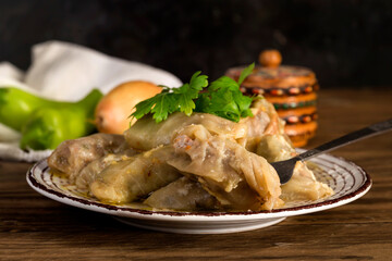 Cabbage rolls in a plate on a wooden table