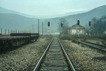 Fototapeta premium Red lights on a railway signals in the abandoned railway station of Kosovska Mitrovica, or Mitrovice, in Kosovo, at the border between the Albanian and the Serbian part of the city, divided...