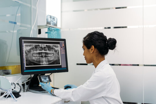 Female dentist at work - Powered by Adobe