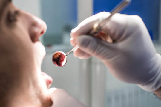 Dentist examining patient's teeth