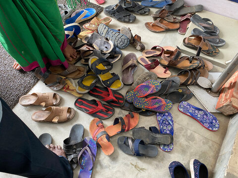 Shoes are scattered outside a clinic in covid situation