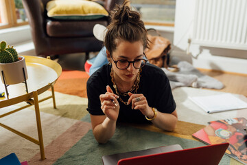 Serious Student Using Laptop At Home