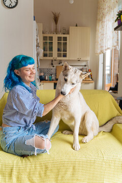 joyful owner pats her dog by the neck