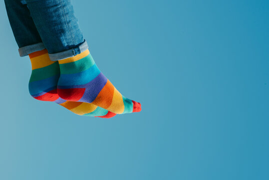 man wearing jeans and rainbow socks