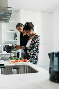 Mother and daughter cooking together