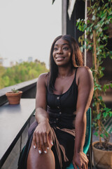 happy black girl sitting while smiling