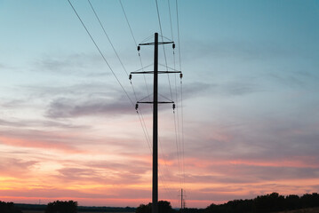 High-voltage electric poles at sunset.