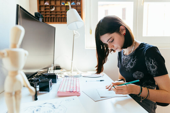 Cute girl drawing at her desk