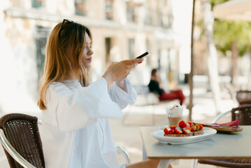 Influencer photographing her healthy breakfast outdoors