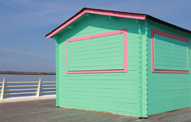 green wooden hut on pier