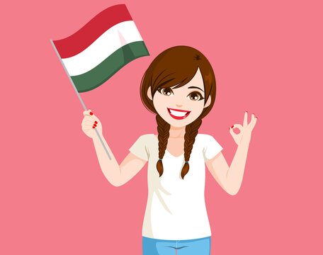 Beautiful young Hungarian woman holding Hungary flag on pink background and making ok hand gesture sign