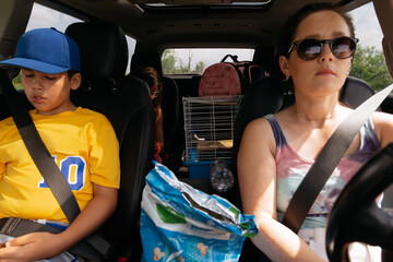 Mother driving kids in car. 