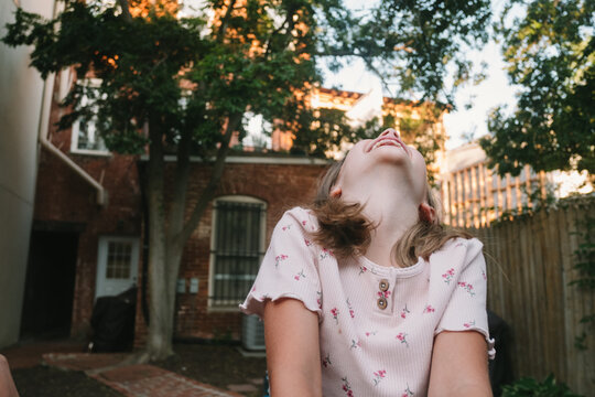 Young Girl Throws Her Head Back and Laughs
