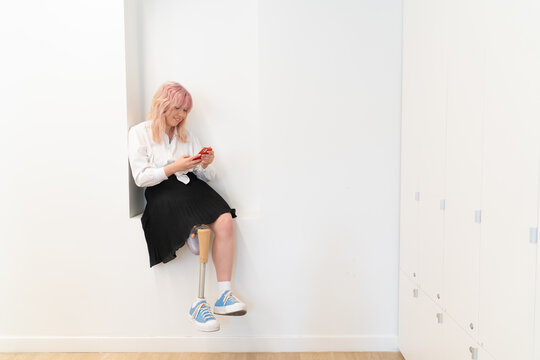 Woman With Leg Disability Using  Cellphone