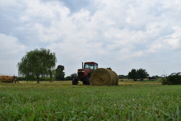 Tractor and Hay Bale in a Field