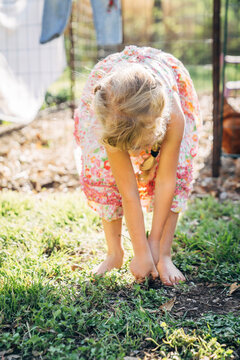 Girl weeding in home garden