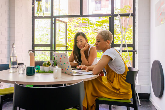 Two Multiracial Women Working In The Office. 