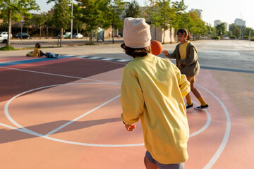 Kids playing basketball at neighborhood court