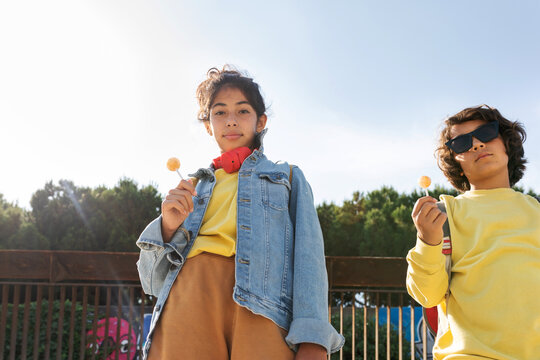 Kids eating lollipops outdoor