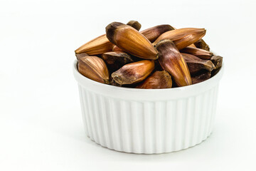 red brazilian pine seeds on isolated white background.