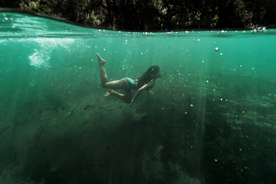 Girl Coming Up From Freshwater Spring