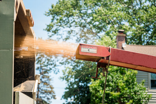 Tree chipper shooting sawdust in a truck