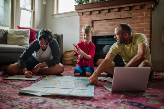 Father points to map on floor