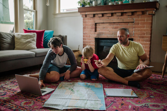 Young boy and dad taking pictures of map