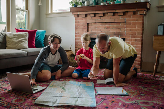 Dad and two sons looking at map