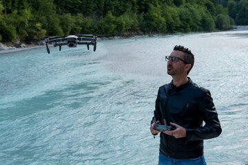 Man flying a drone at the lake on mountains
