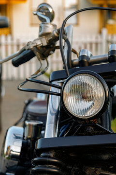 Motorbike with round headlamp in yard