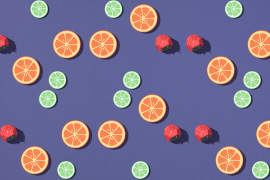Red strawberry, lemon colorful pattern on purple background.